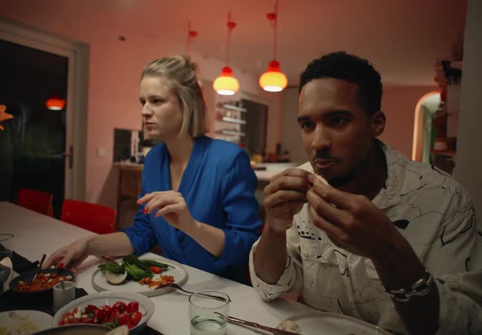 Friends talk while eating during dinner party at night
