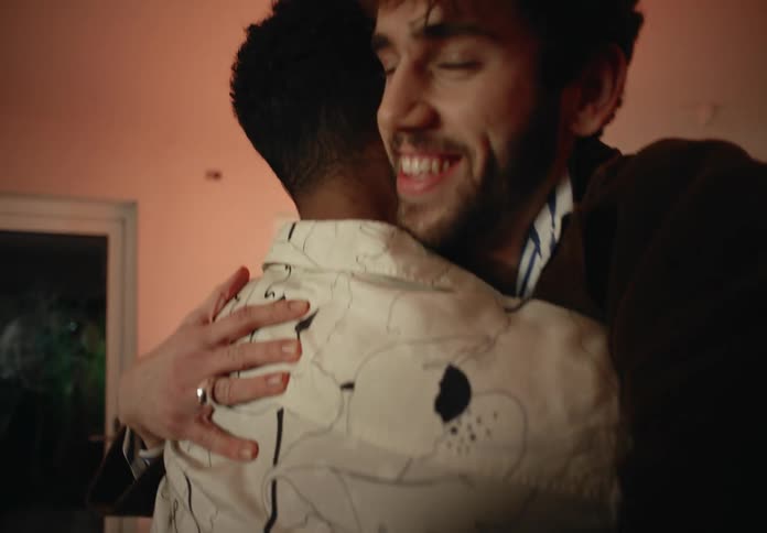 Gay and straight couples greet and hug each other at home