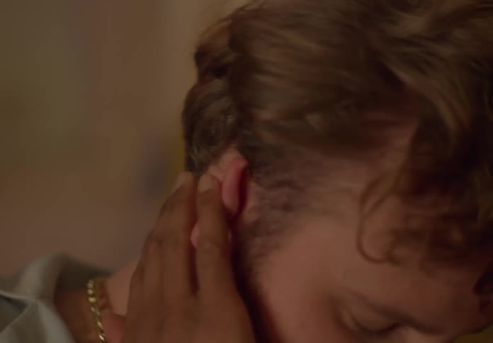Man strokes and touches mans hair
