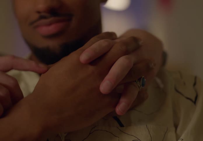 Gay couple holds each other lovingly