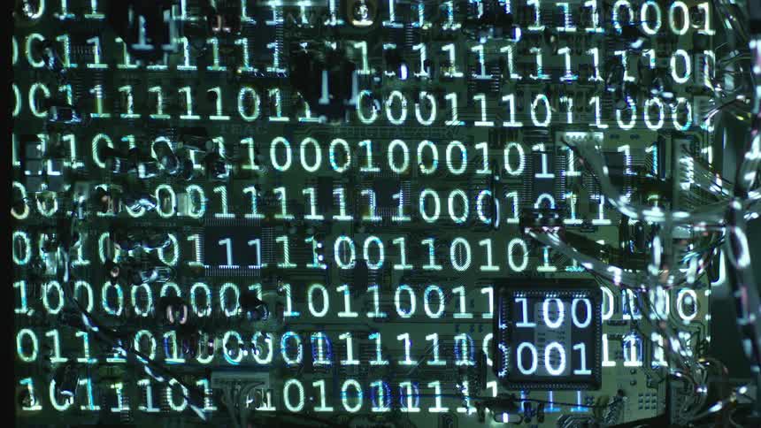 A series of zeros and ones flash across a screen