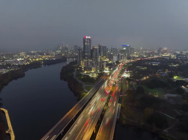 Ext nighttime asian city skyline with waterway traffic lights time lapse