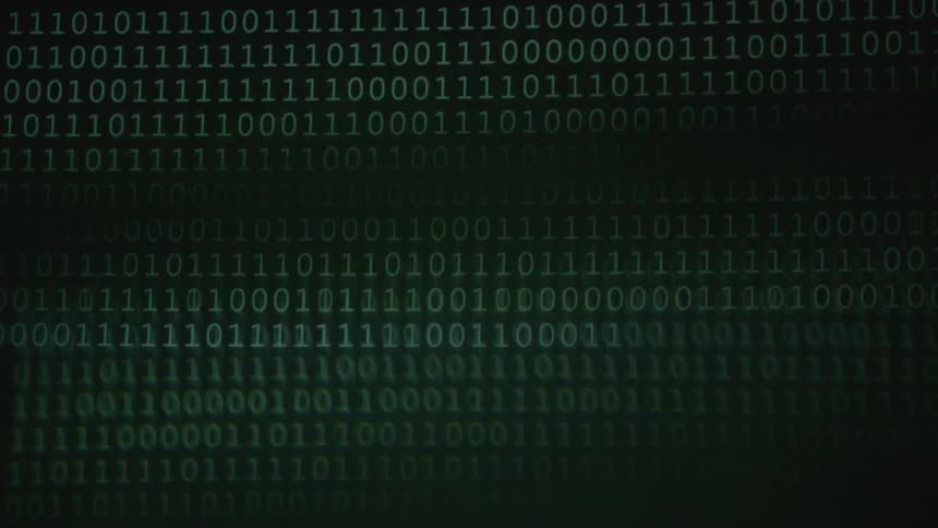 Ones and zeroes flash across a screen