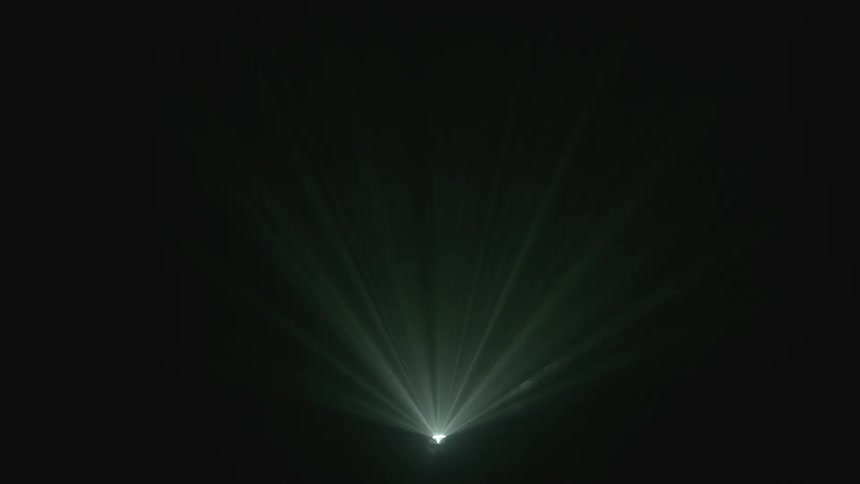 A spot light flashing in a dark room