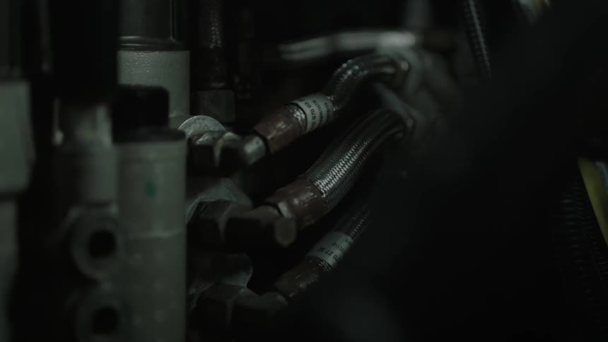 Hoses on an engine block coming into focus