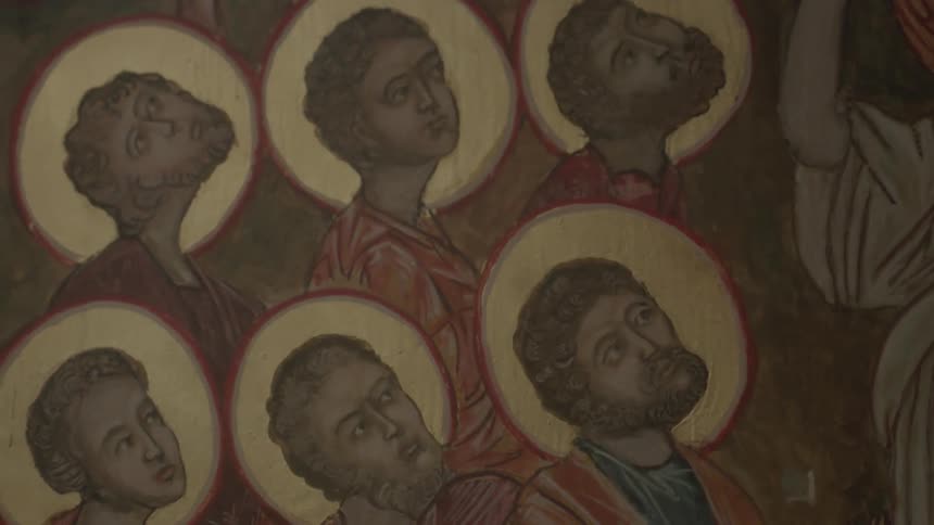 An image of six saints painted on a surface