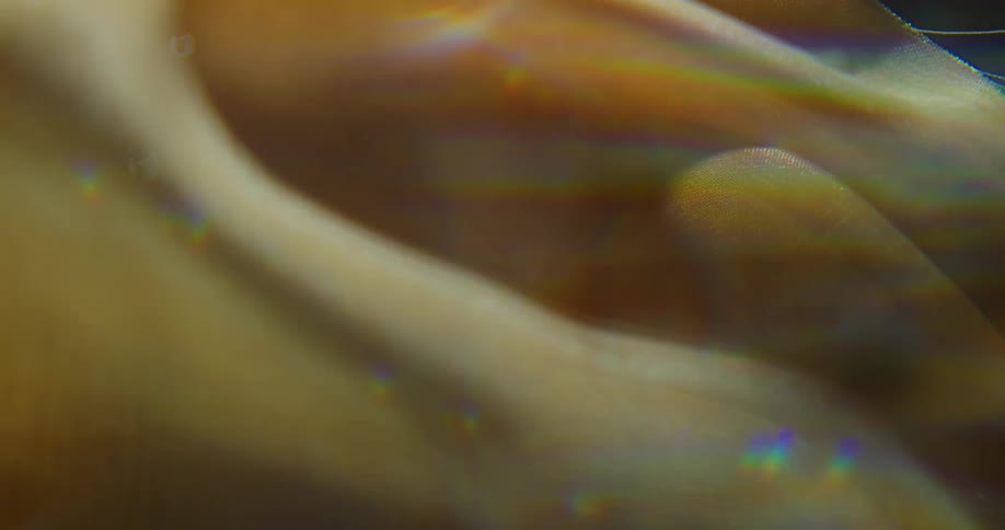 A wave moving yellow cloth with a blink of light