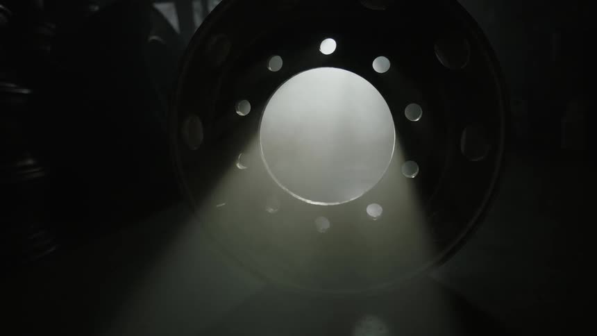 Wheel rims are in a dark garage
