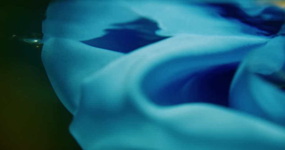 A piece of blue fabric floating underwater