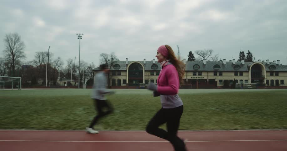 A woman jogging on a track and field