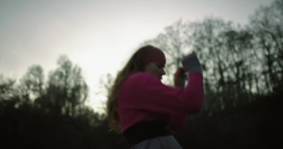 Woman doing a yoga exercise and dancing in the dawn