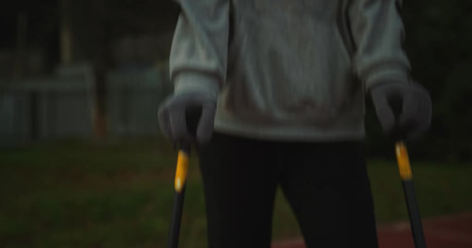 A young woman is on crutches outside in the middle of the day time