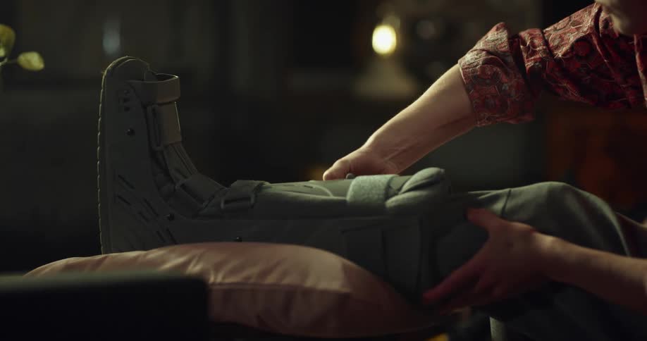 A man tying a leg brace to his leg