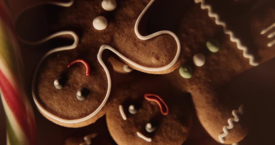 A closeup shot of gingerbread cookies with icing buttons and other decorations