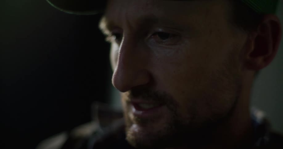 Close up of mans head with goatee beard reading