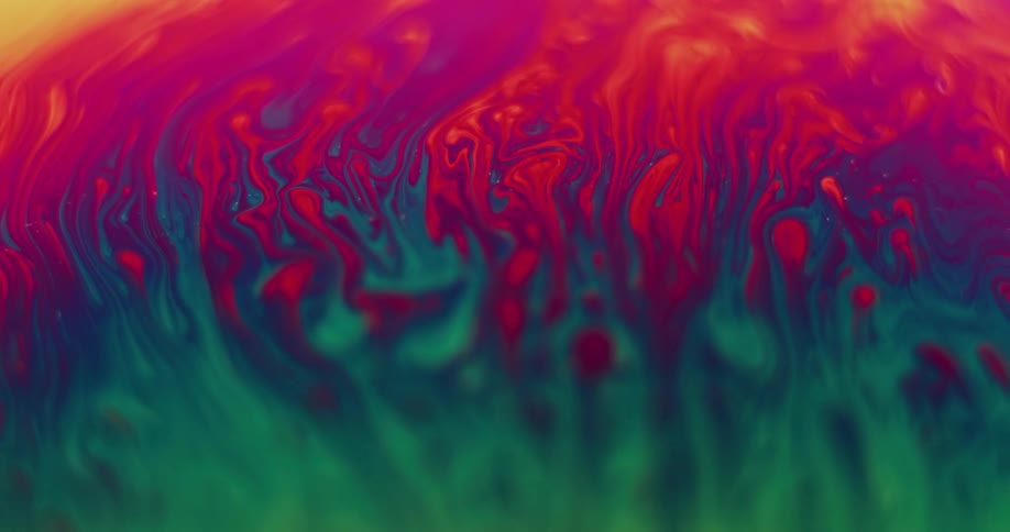 Orbs of red move up to the red stripe creating purple trails as they move over the green