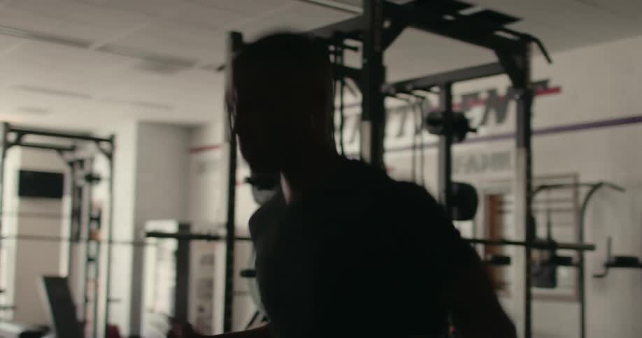 A young man doing a skipping exercise in a gym
