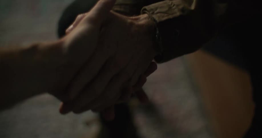 Two people shake hands
