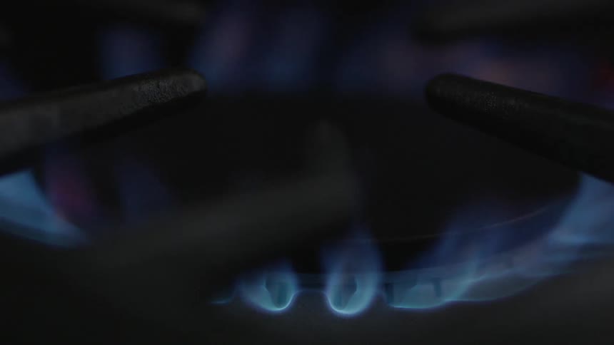 The burner on a gas stove igniting