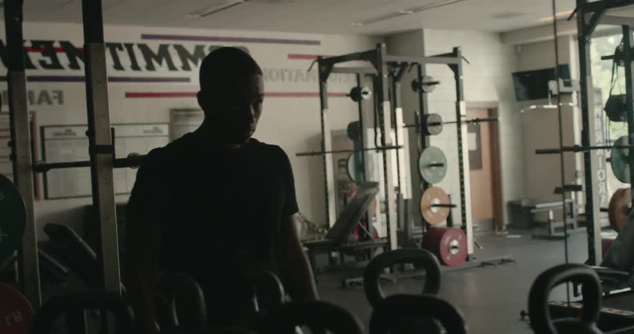 A man stretches in front of the mirror