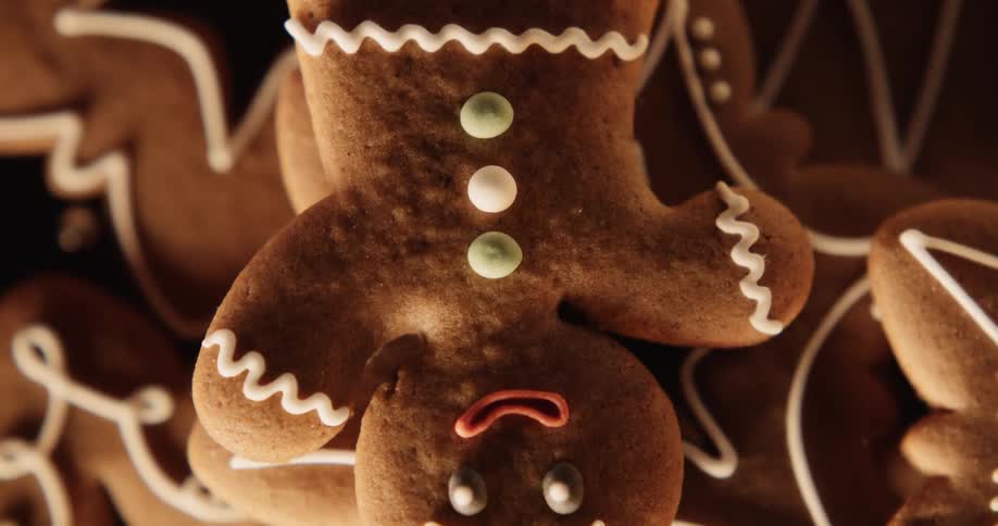 Gingerbread cookies are shown orbiting with a soft light flickering on them from off camera