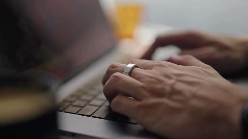 A person is typing on a laptop