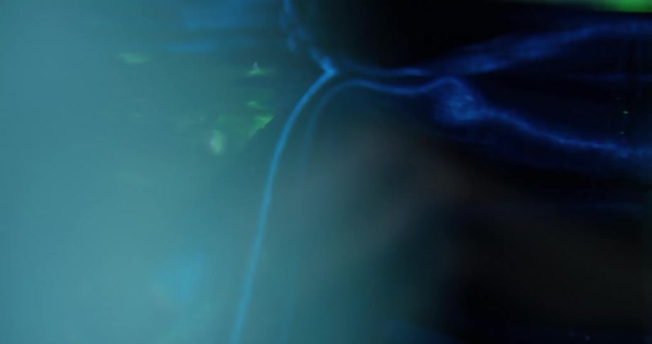 Electric blue fabric contrasts with vibrant green tinted water