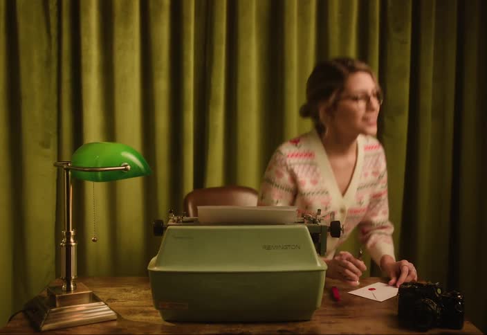 A woman gets up from the desk