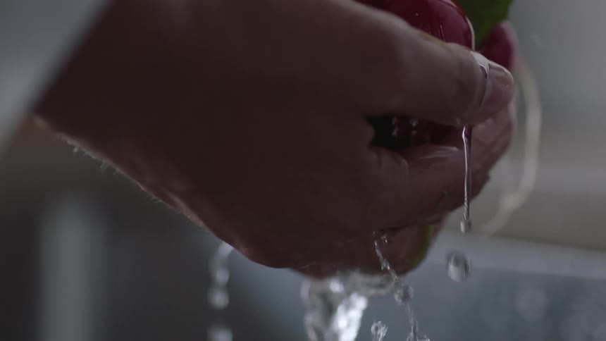 A chef rinsing radishes