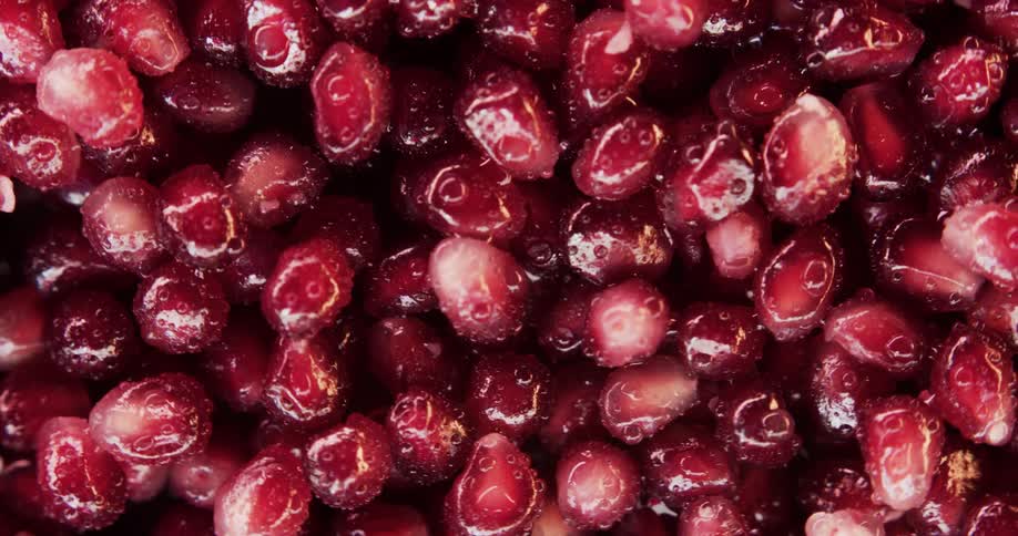 Mass of pomegranate seeds gleam wetly