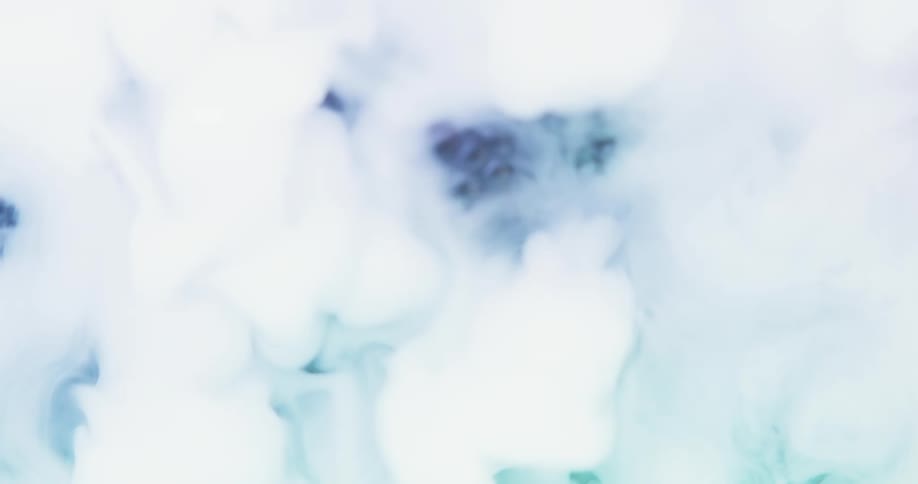 Closeup of a bunch of loose blackberries with green light reflected off of them and steam coming in and eventually obscuring them