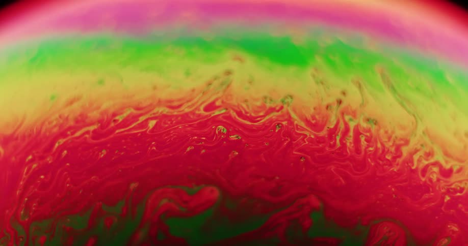 Fluorescent stripes move and blend as variegated wisps stretch across the surface on an orb