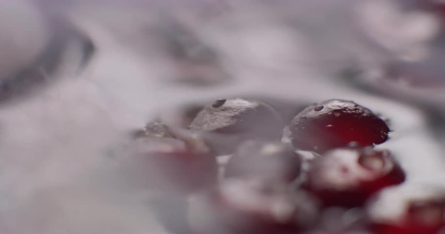 Bunches of grapes are washed in a sink