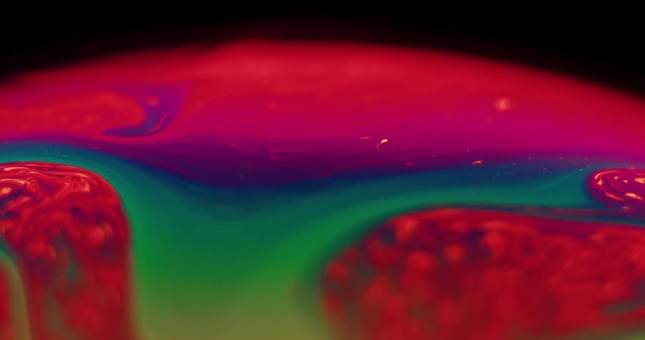 Swirling mixture of vivid colors form a sphere contrasting with black background