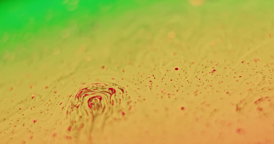 Red particles move over the yellow surface as it blends with green