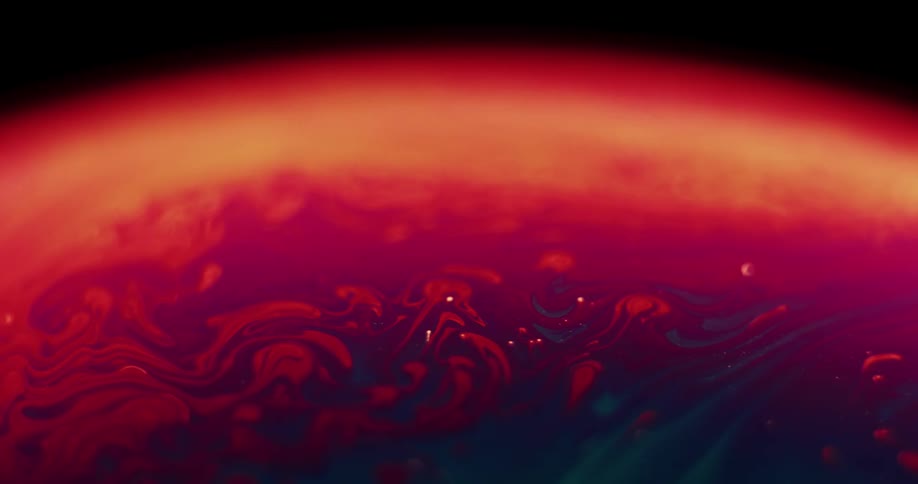 The organic surface of a sphere is moving as variegated stripes of colors are mixing over the red and yellow