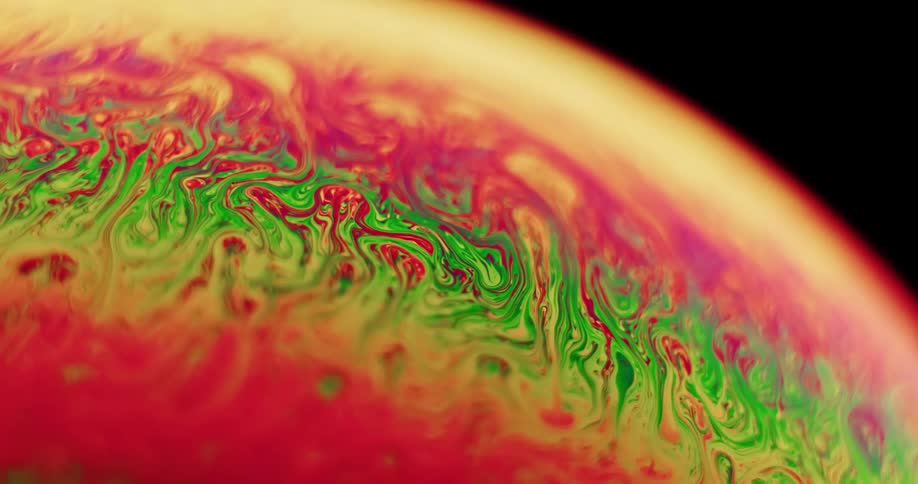 Fluorescent colors stretch and move as they blend across the surface of a sphere