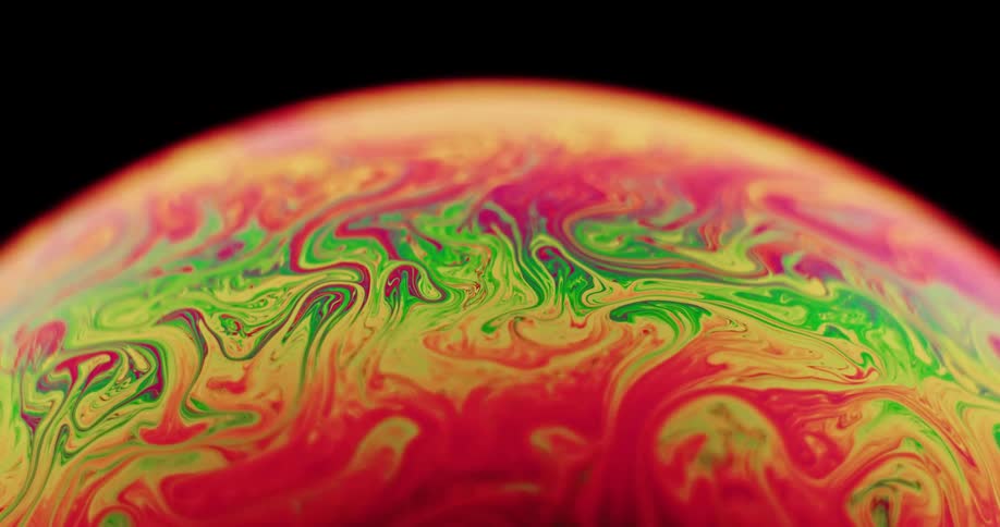 Fluorescent stripes of an organic substance come to life as they stretch and blend as they move across the surface of a sphere