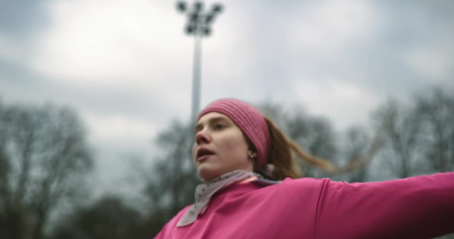 A woman is stretching outdoors during the spring