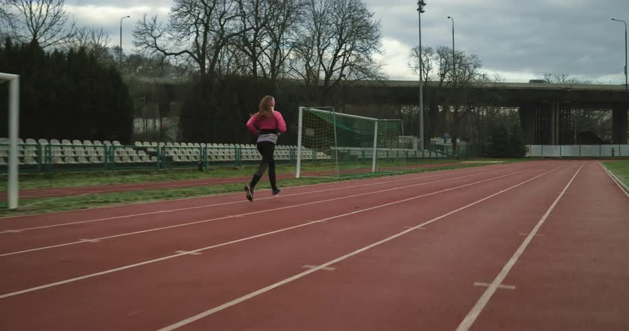 A woman is running on the track