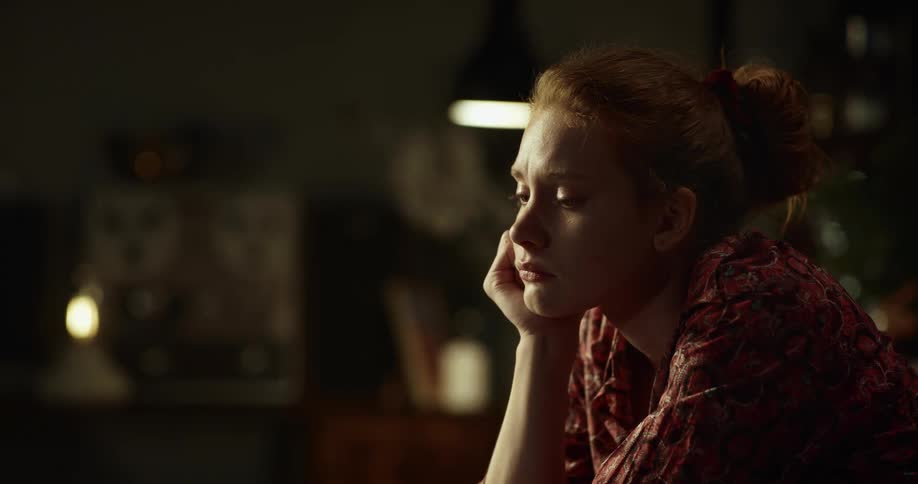 A woman looking to the side and thing about something