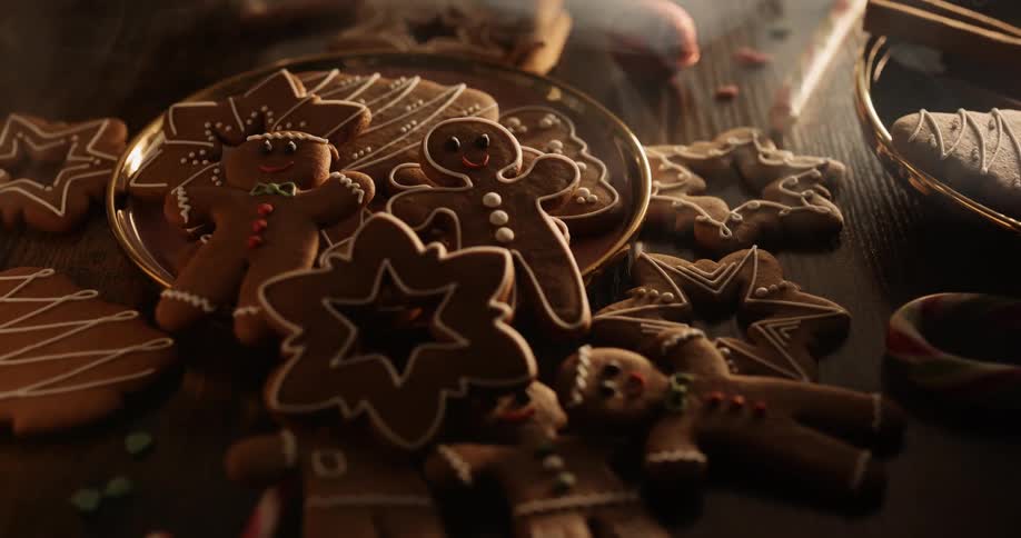 Smoke floats over a plate full of cookies and gingerbread men scattered across the table