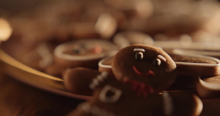 Gingerbread men flow off of tray onto wooden table