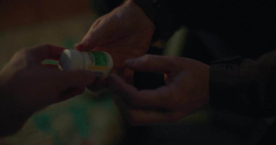 An addict taking drug from someone with his hands shaking