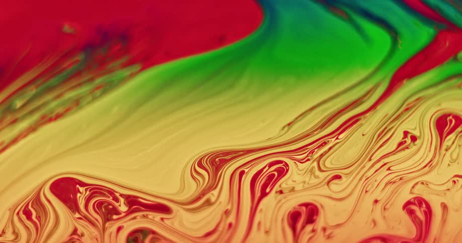 Bright paint colors of red yellow and green mixing together