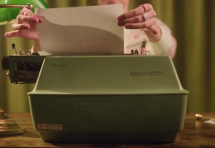 A woman is using a type writer in her office
