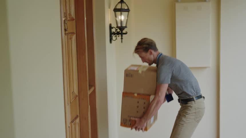 Delivery man knocking on front door delivering packages