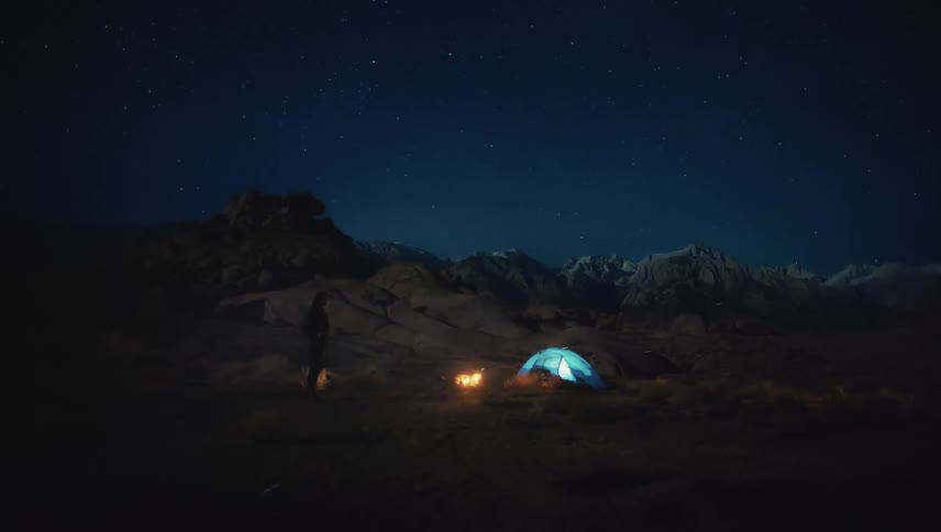 The peaceful and cozy atmosphere of camping at night with tents and a warm fire the footage showcases the beauty of nature and the simple pleasures of camping