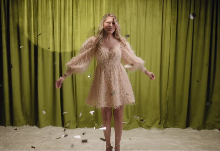 Woman dancing around confetti
