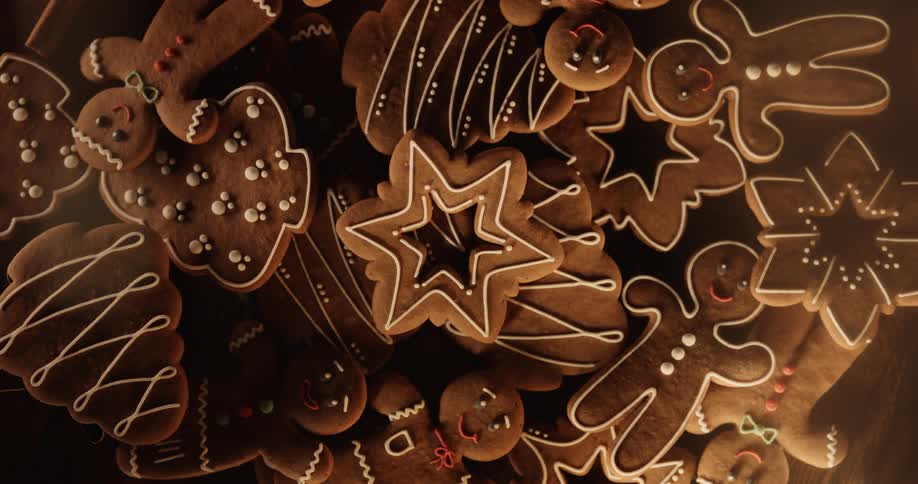 Smiling gingerbread men are on a tray with other holiday cookies